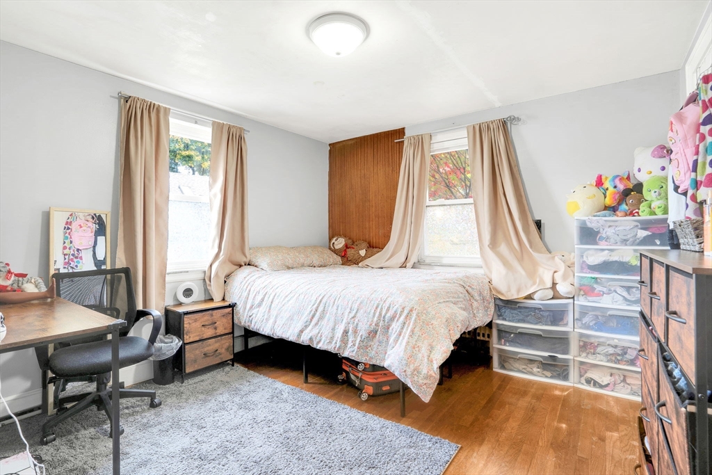 39 Range Road Boston, MA 02124 - Photo 14 of 25 a bedroom with a bed and a window