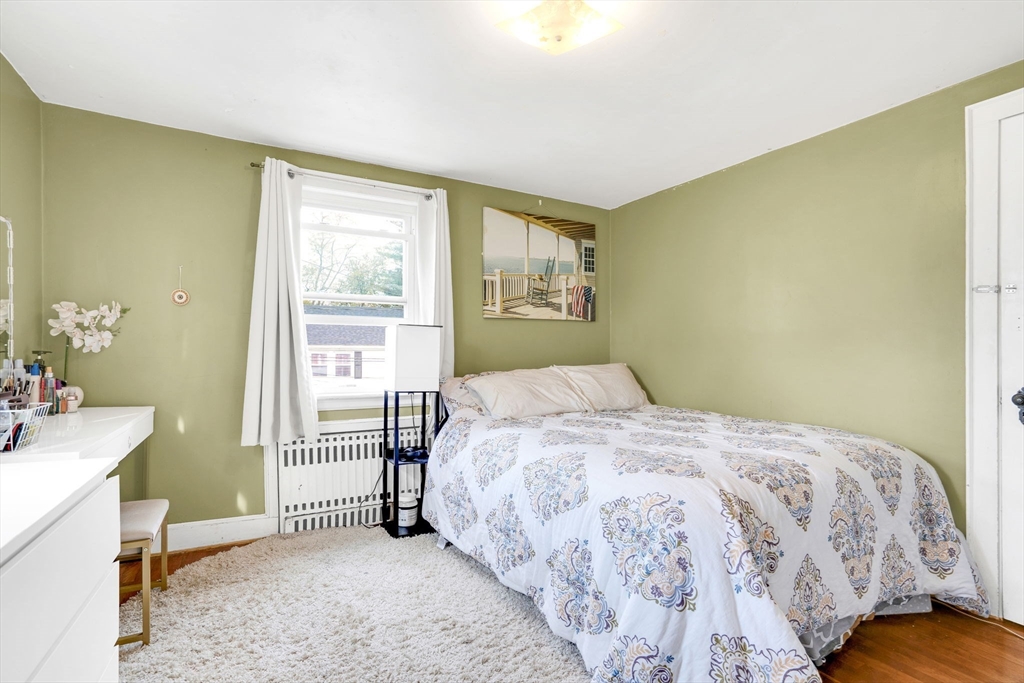 39 Range Road Boston, MA 02124 - Photo 16 of 25 a bedroom with a bed and a window