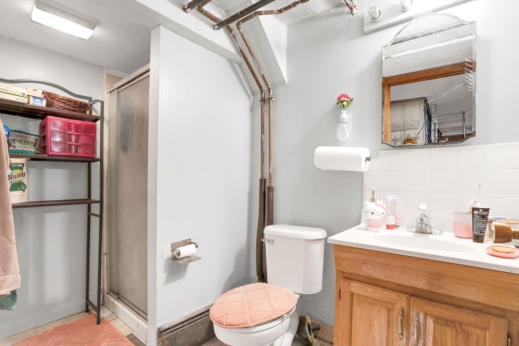 39 Range Road Boston, MA 02124 - Photo 18 of 25 a bathroom with a sink a toilet and a mirror