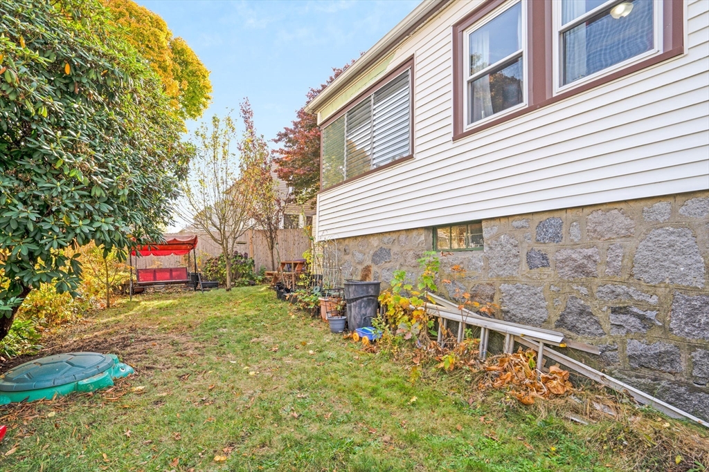 39 Range Road Boston, MA 02124 - Photo 23 of 25 a yellow and red brick house with a small yard