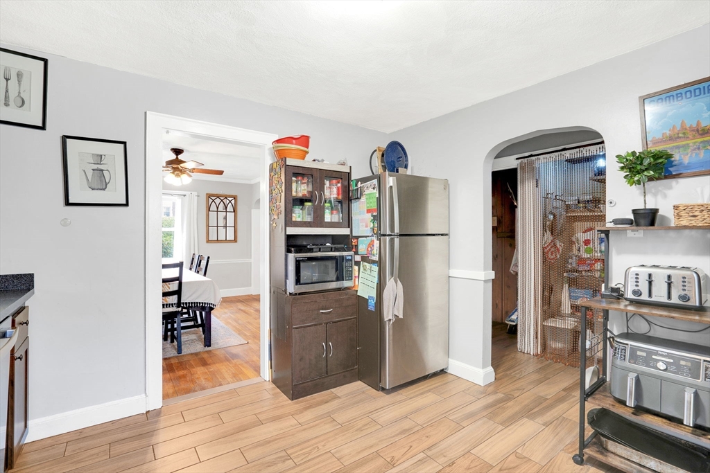 39 Range Road Boston, MA 02124 - Photo 6 of 25 a kitchen with stainless steel appliances a refrigerator and wooden floor