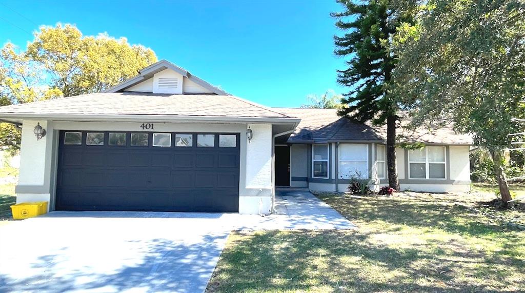 401 Basil Circle Kissimmee, FL 34759 - Photo 1 of 1 a front view of a house with a yard