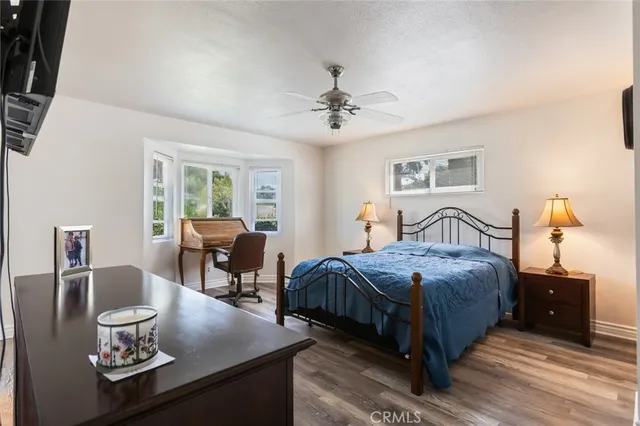 a bedroom with bed a table and chair