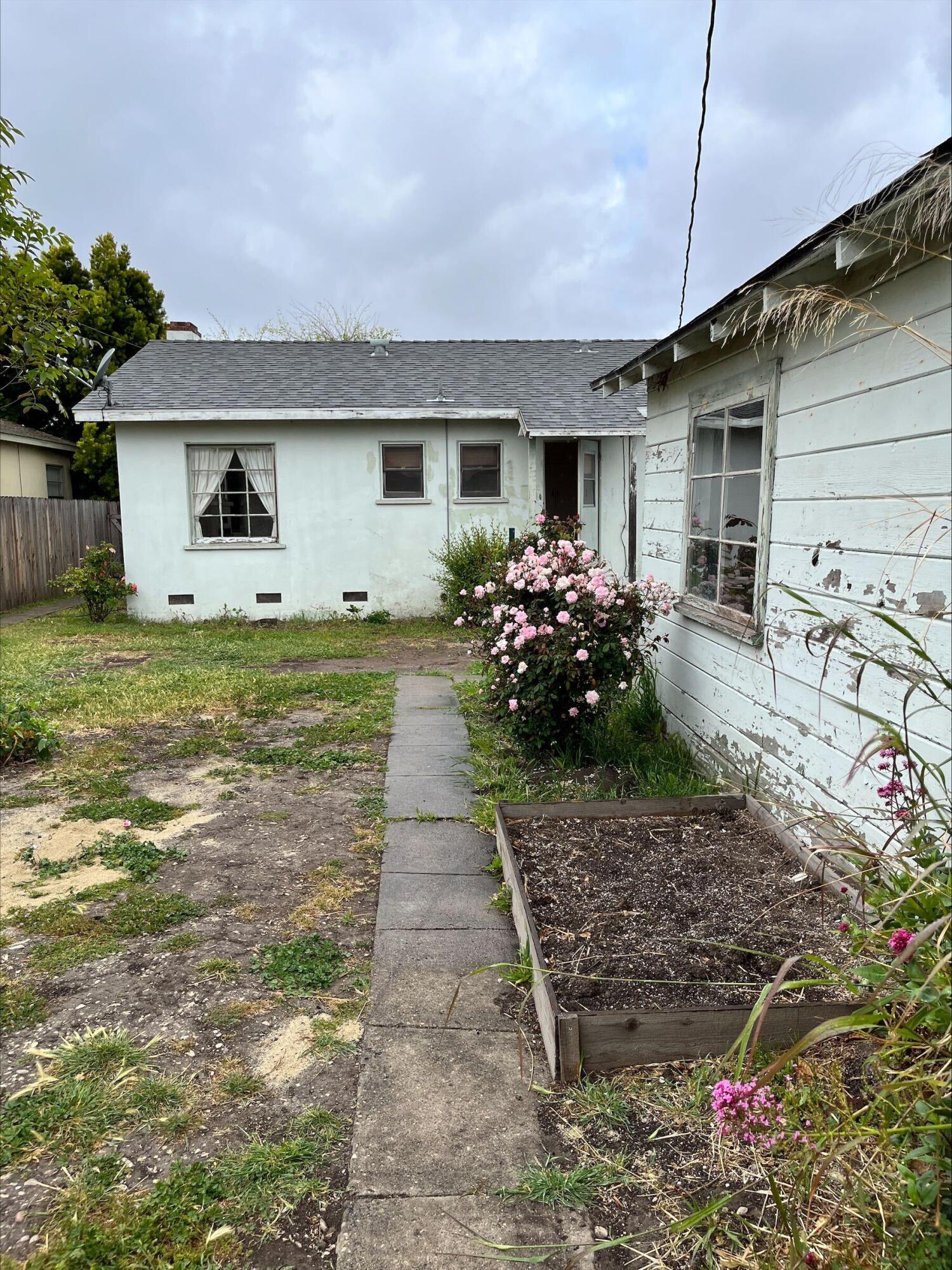 230 South L Street Lompoc, CA 93436 - Photo 13 of 14 a front view of a house with garden