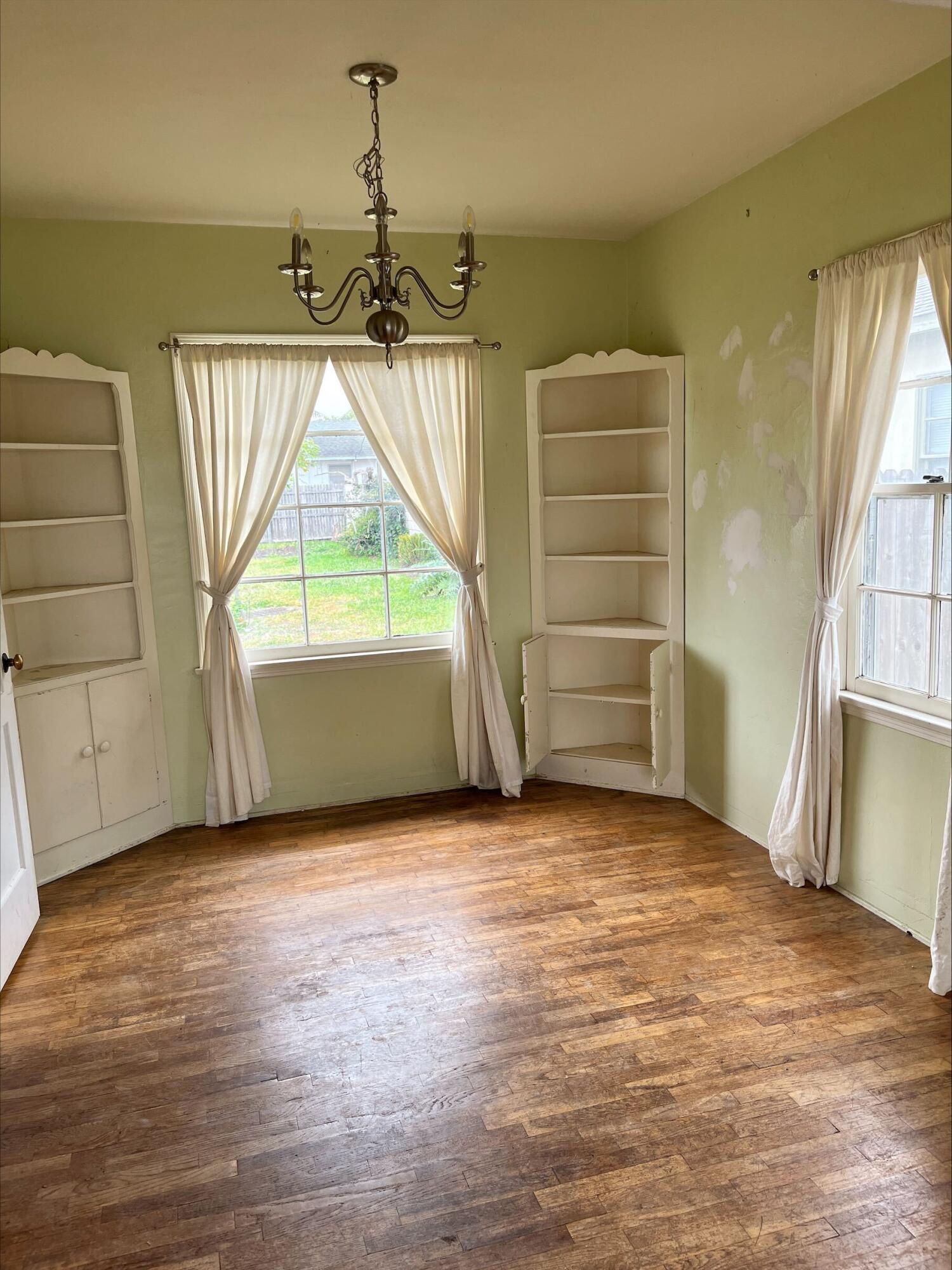 230 South L Street Lompoc, CA 93436 - Photo 7 of 14 an empty room with windows and closet