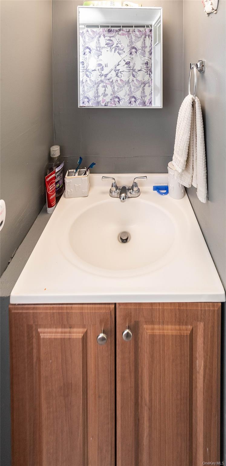 46 Hasbrouck Street Newburgh, NY 12550 - Photo 11 of 26 a bathroom with a sink and a mirror