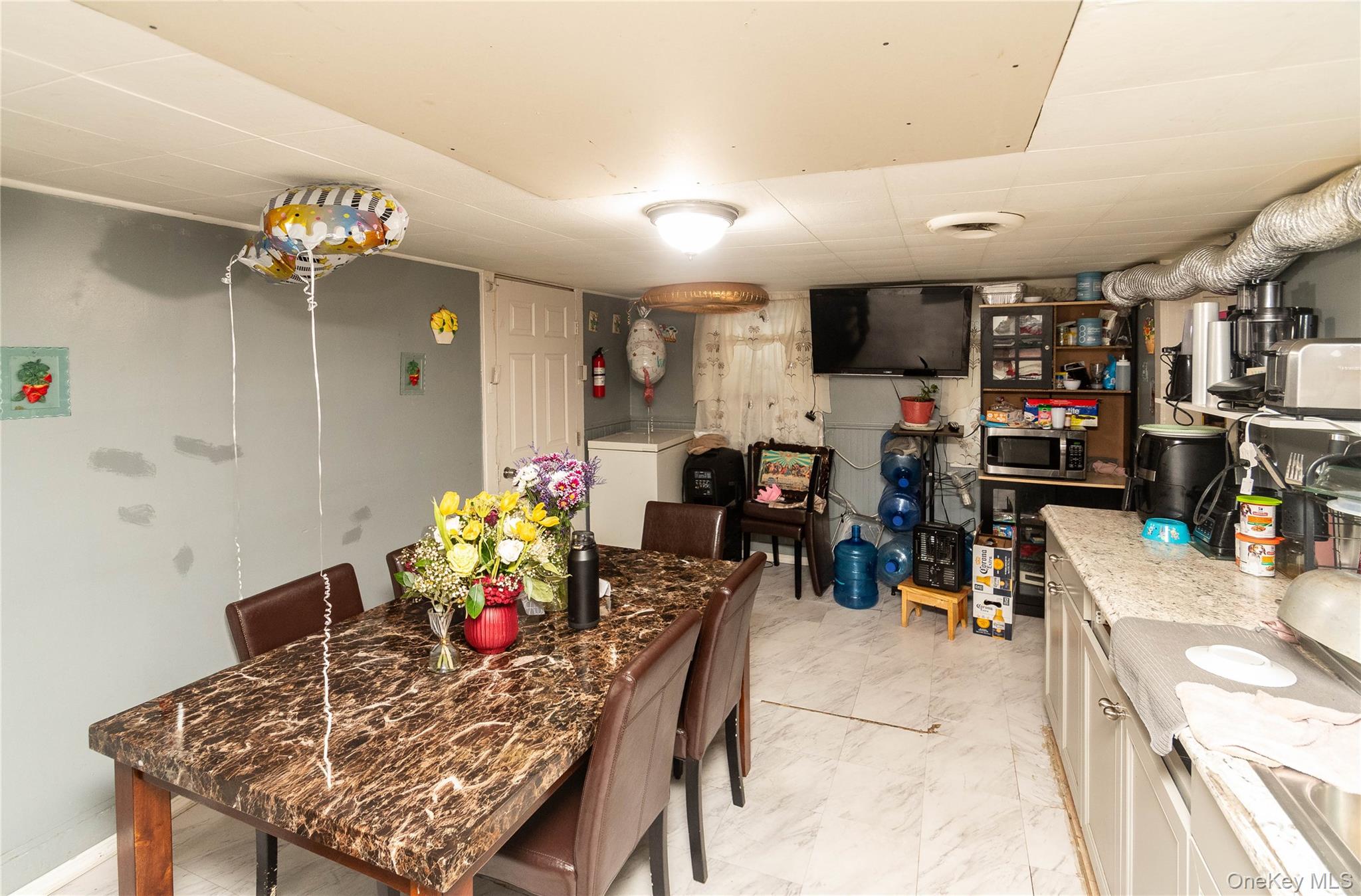 46 Hasbrouck Street Newburgh, NY 12550 - Photo 21 of 26 a view of a dining room with furniture and a chandelier