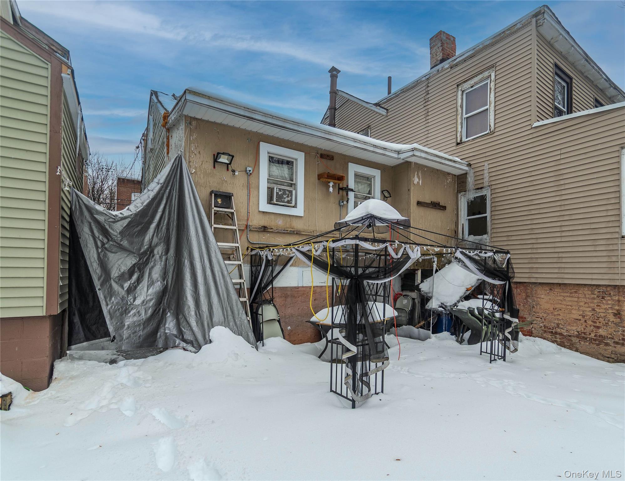 46 Hasbrouck Street Newburgh, NY 12550 - Photo 24 of 26 a view of backyard with wheel chair and wooden fence