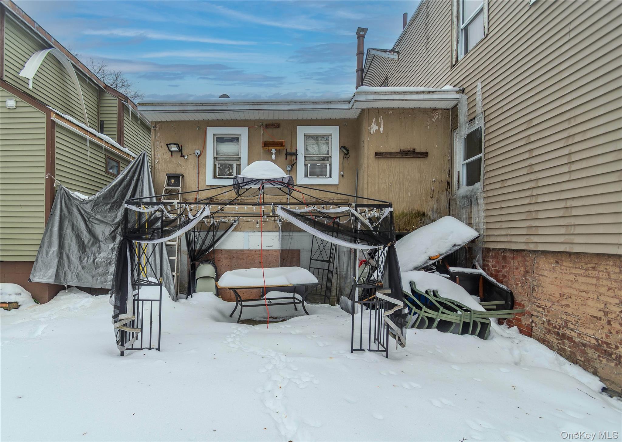 46 Hasbrouck Street Newburgh, NY 12550 - Photo 25 of 26 a view of a patio with table and chairs and barbeque