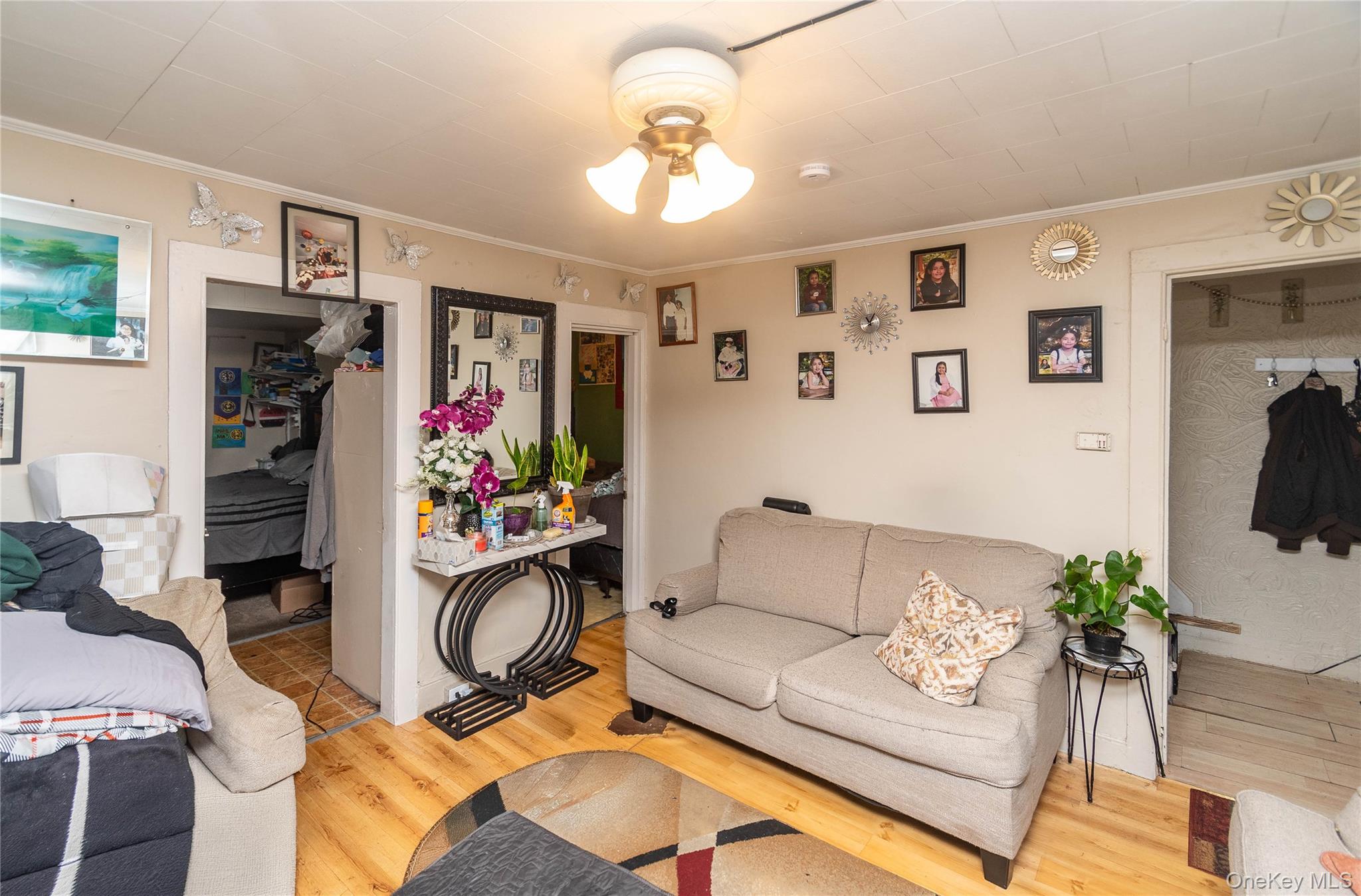 46 Hasbrouck Street Newburgh, NY 12550 - Photo 4 of 26 a living room with furniture and a chandelier