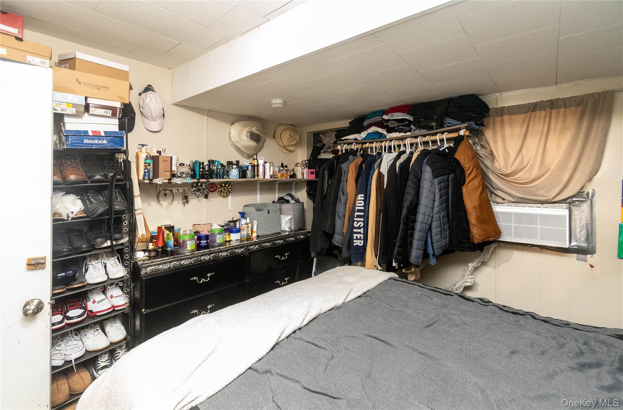 46 Hasbrouck Street Newburgh, NY 12550 - Photo 8 of 26 a walk in closet with clothes and shoes