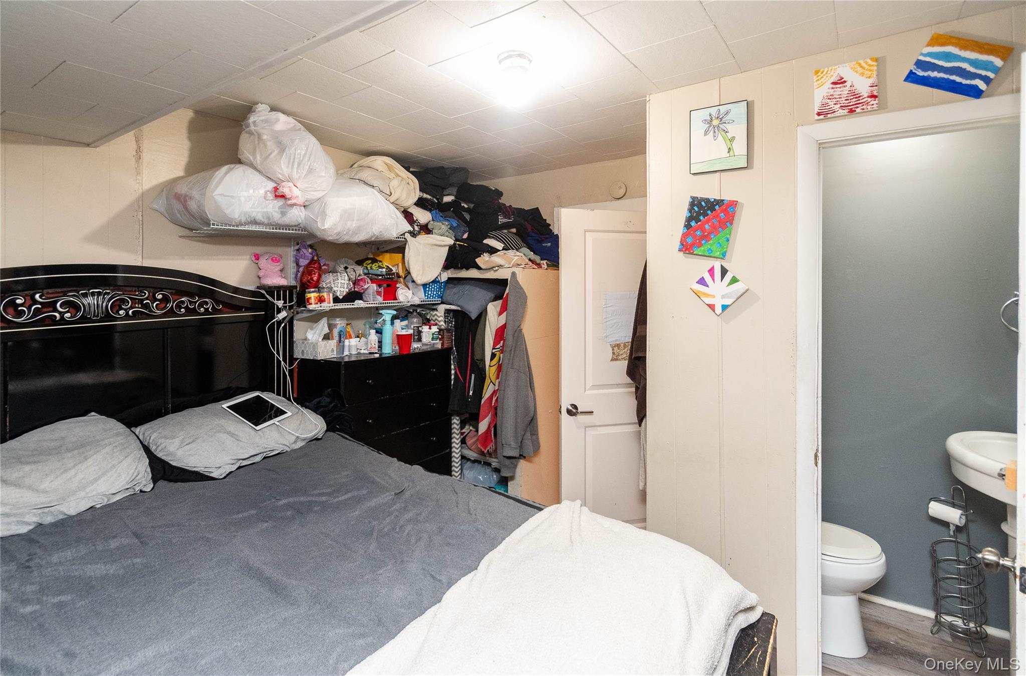 46 Hasbrouck Street Newburgh, NY 12550 - Photo 9 of 26 a bedroom with a bed and a chandelier