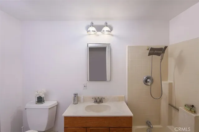 a bedroom with a bed and a lamp