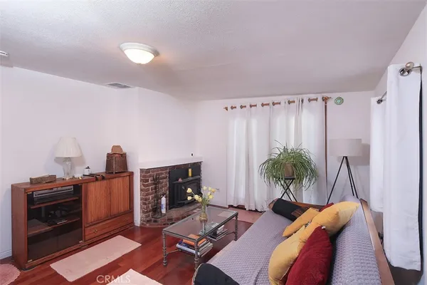 a bedroom with furniture and wooden floor