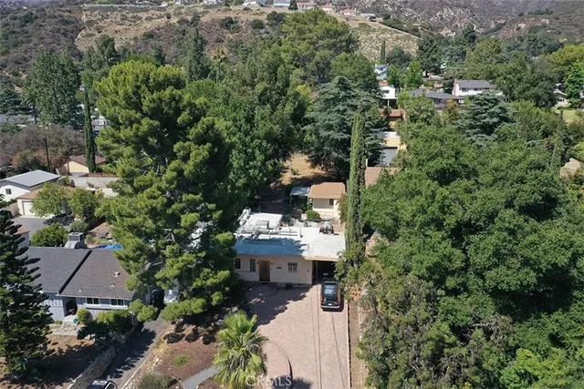 an aerial view of a house with a yard and garden