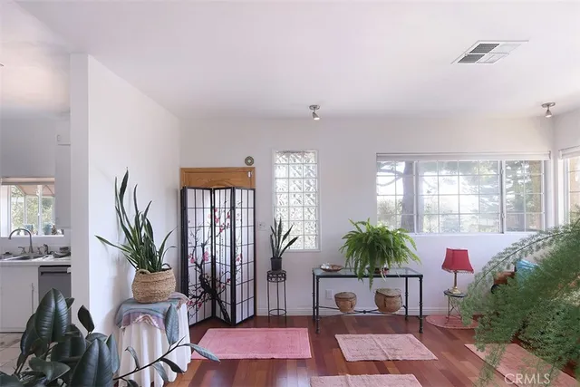 a living room with furniture potted plant and a window