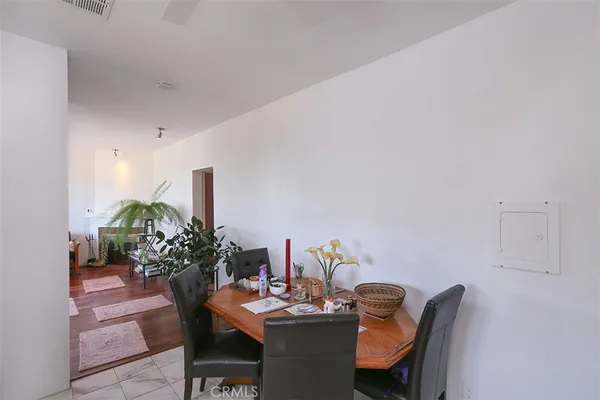 a dining room with furniture and wooden floor