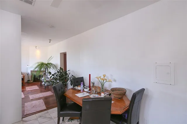 a dining room with furniture and wooden floor