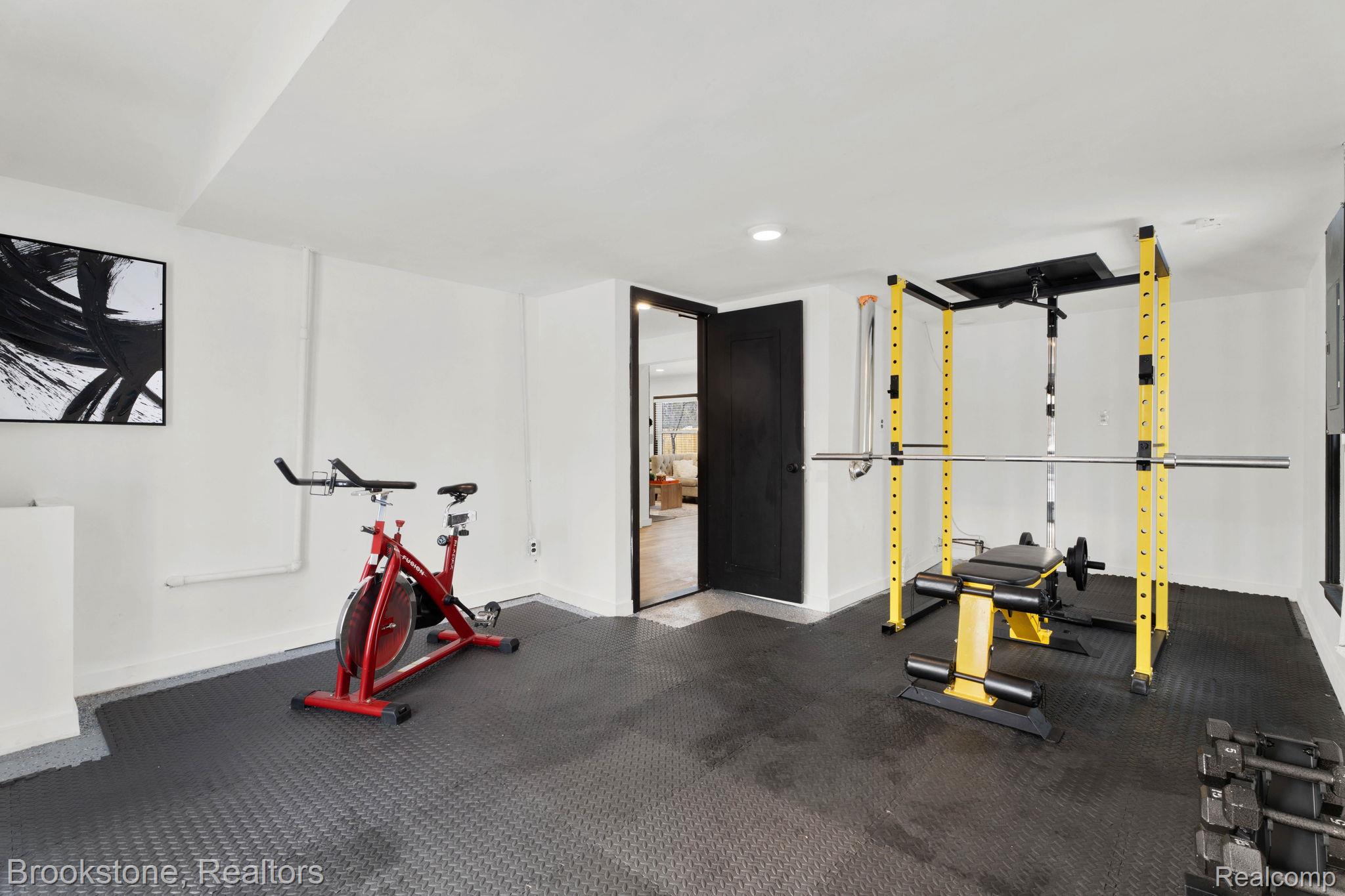16046 West 13 Mile Road Franklin, MI 48025 - Photo 27 of 31 Exercise area featuring dark rubber floors and baseboards