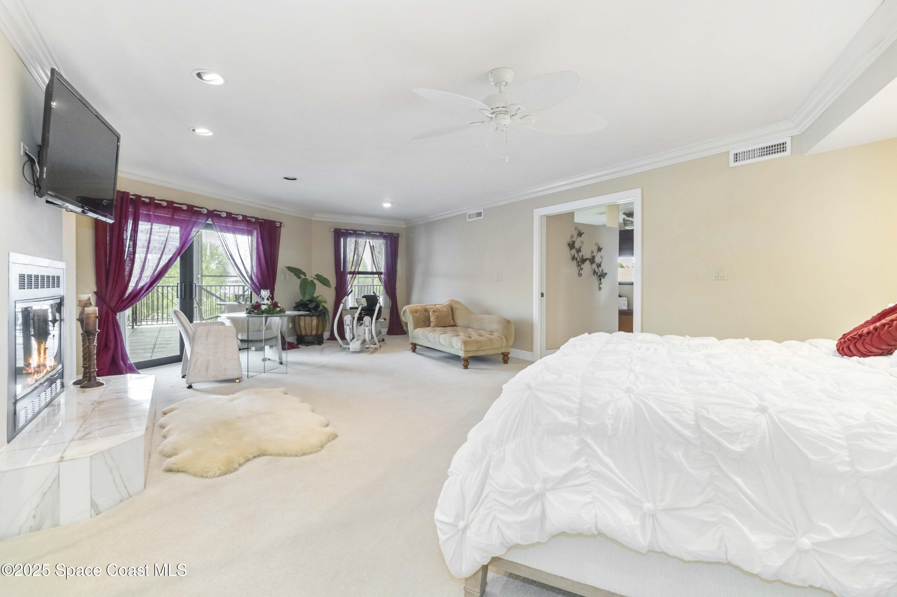 110 Barnacle Place Rockledge, FL 32955 - Photo 17 of 73 a spacious bedroom with a bed and a flat screen tv