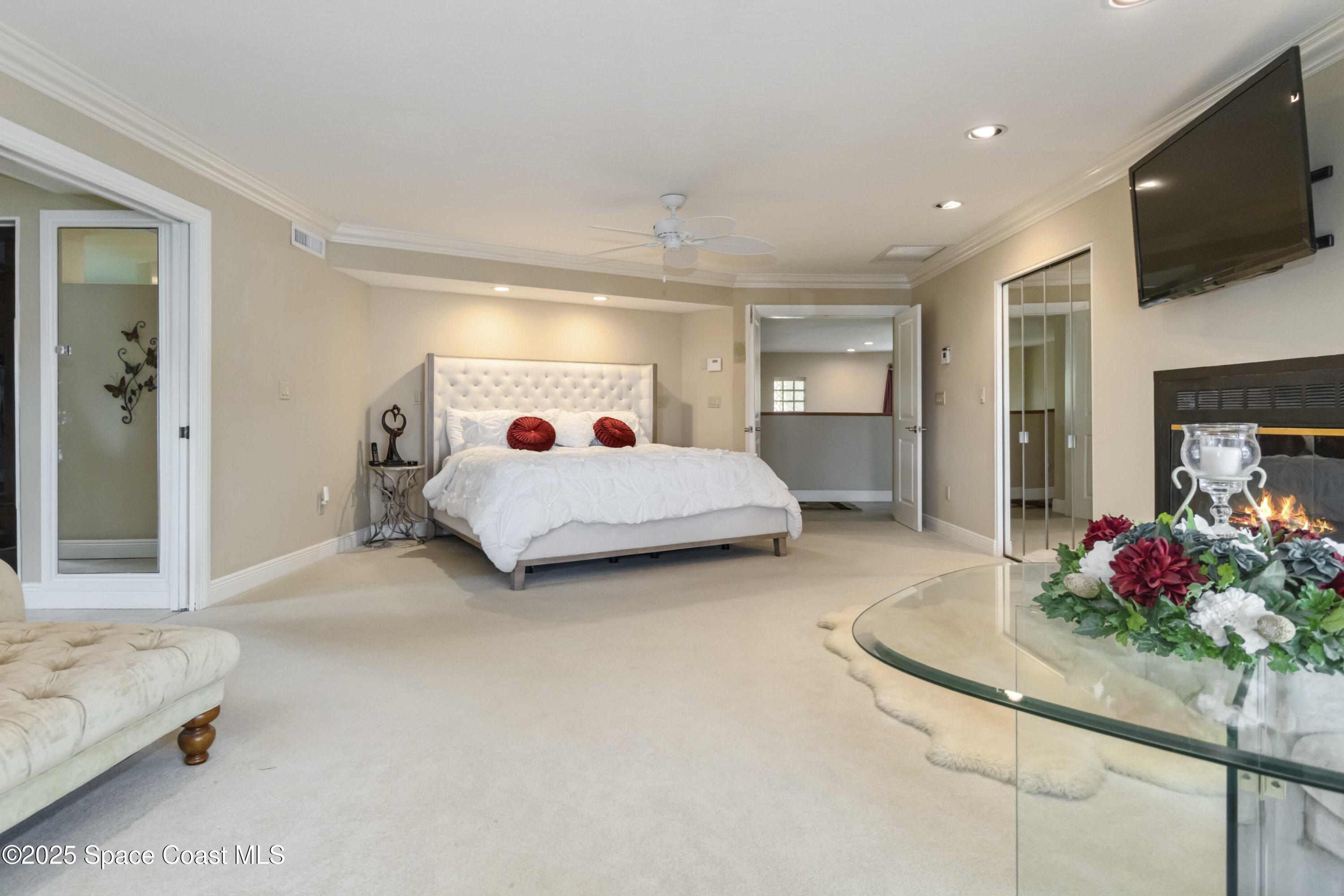 110 Barnacle Place Rockledge, FL 32955 - Photo 19 of 73 a spacious bedroom with a bed and a flat screen tv