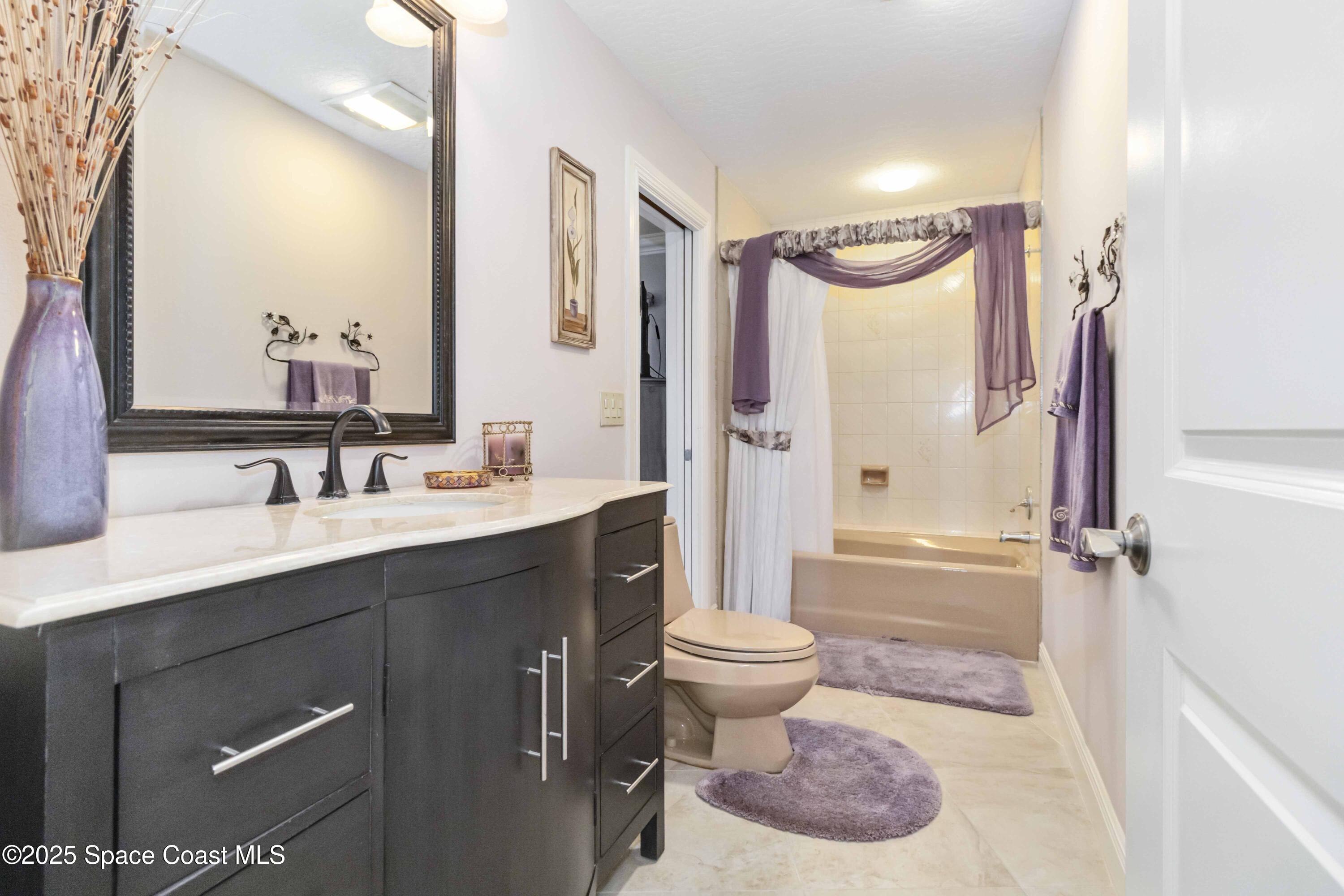 110 Barnacle Place Rockledge, FL 32955 - Photo 24 of 73 a bathroom with a sink toilet a mirror and shower