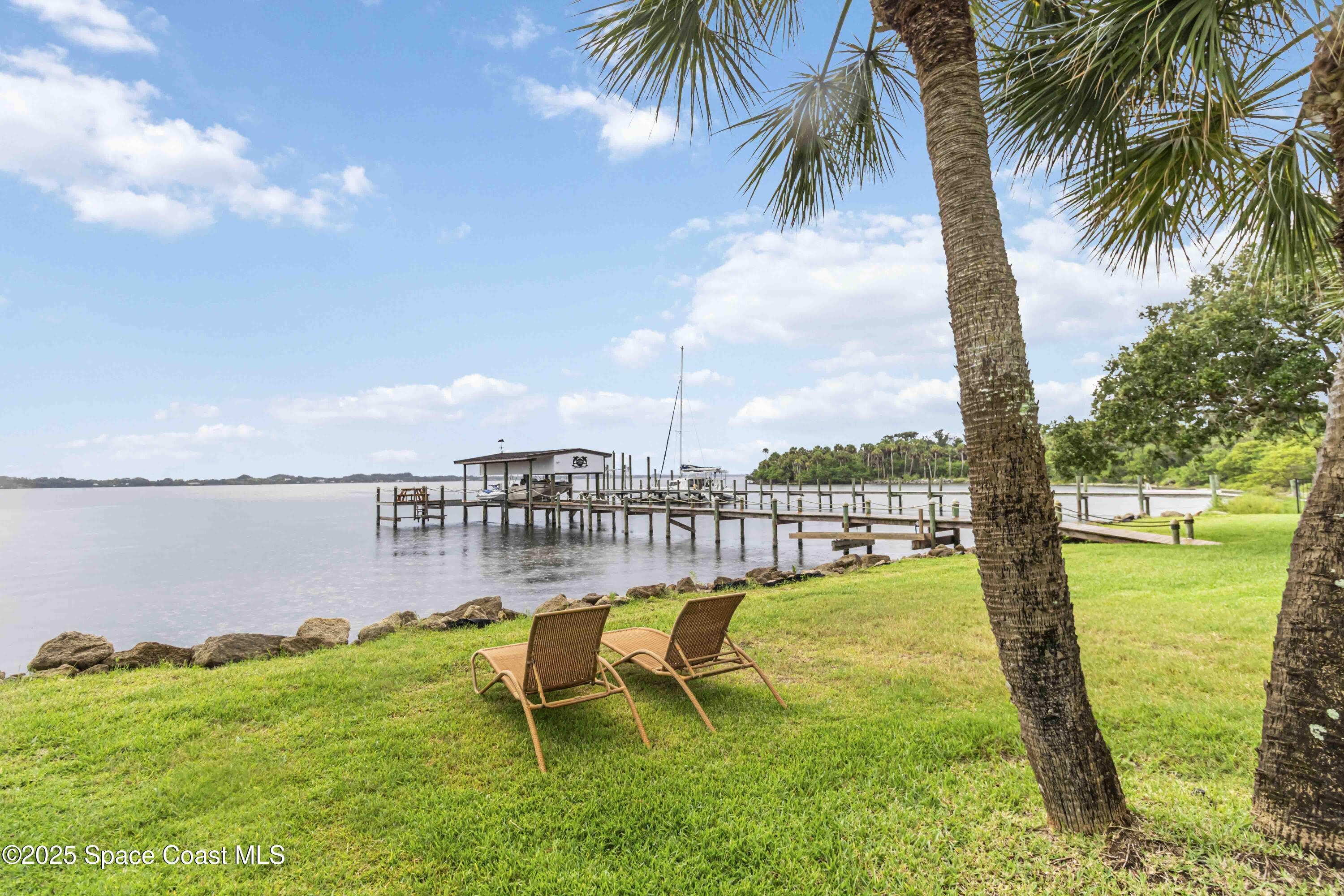 110 Barnacle Place Rockledge, FL 32955 - Photo 57 of 73 a view of a swimming pool with a garden and lake view