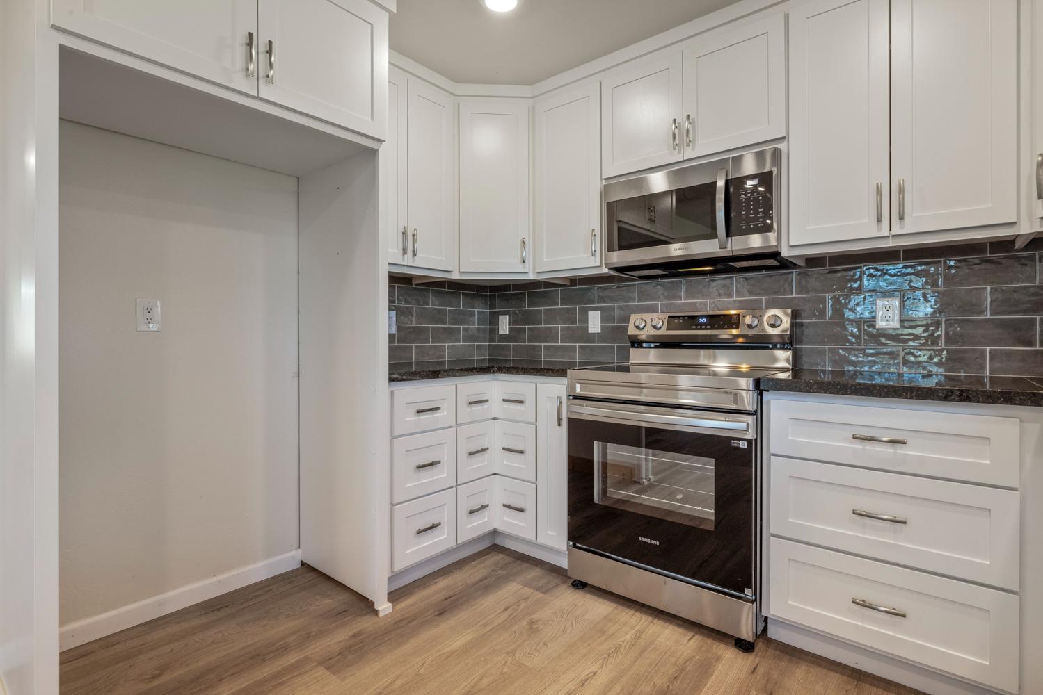 2324 Quail Hill Road Copperopolis, CA 95228 - Photo 11 of 52 a kitchen with stainless steel appliances granite countertop a stove microwave and oven