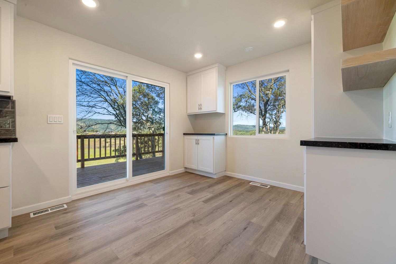 2324 Quail Hill Road Copperopolis, CA 95228 - Photo 15 of 52 a view of an empty room with a window and wooden floor