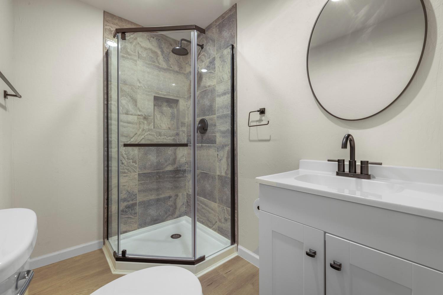 2324 Quail Hill Road Copperopolis, CA 95228 - Photo 23 of 52 a bathroom with a sink a mirror a vanity and a shower