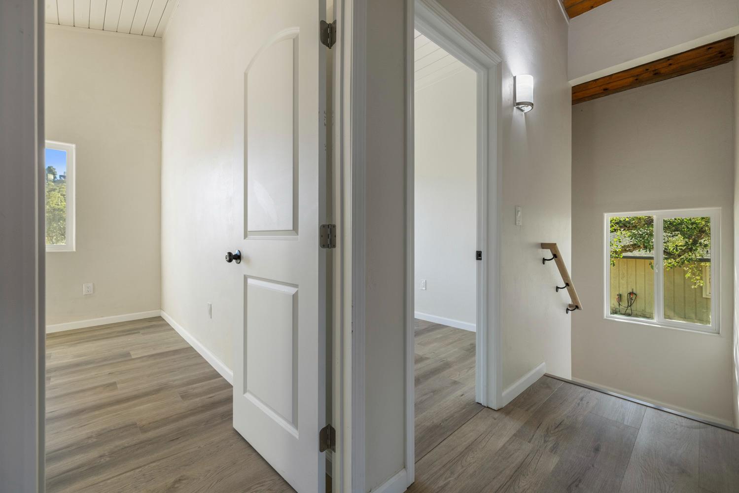 2324 Quail Hill Road Copperopolis, CA 95228 - Photo 31 of 52 a view of a hallway with wooden floor and staircase