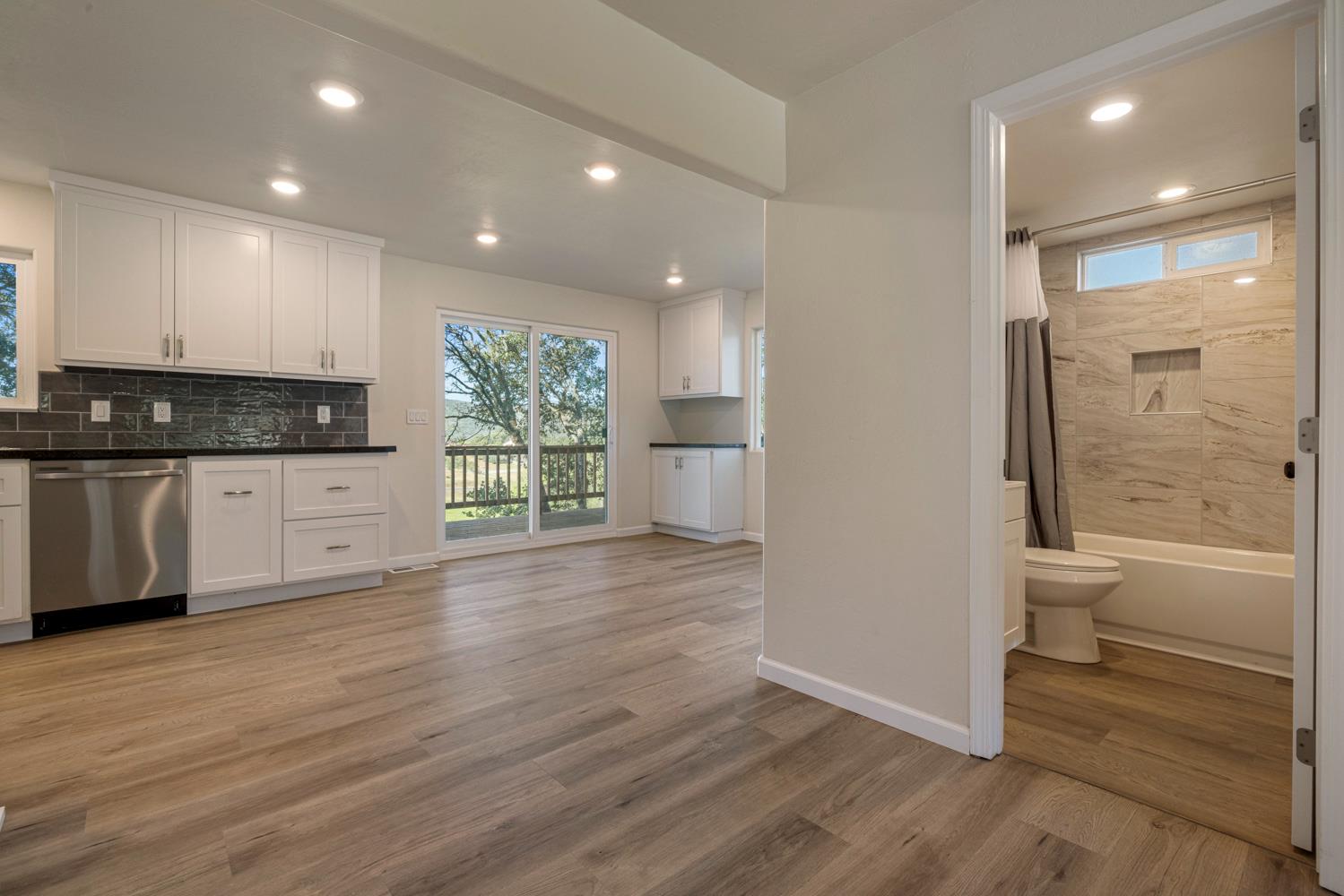 2324 Quail Hill Road Copperopolis, CA 95228 - Photo 8 of 52 a view of a kitchen with wooden floor and a sink