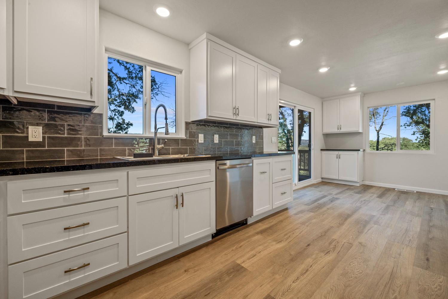 2324 Quail Hill Road Copperopolis, CA 95228 - Photo 9 of 52 a kitchen with white cabinets and sink