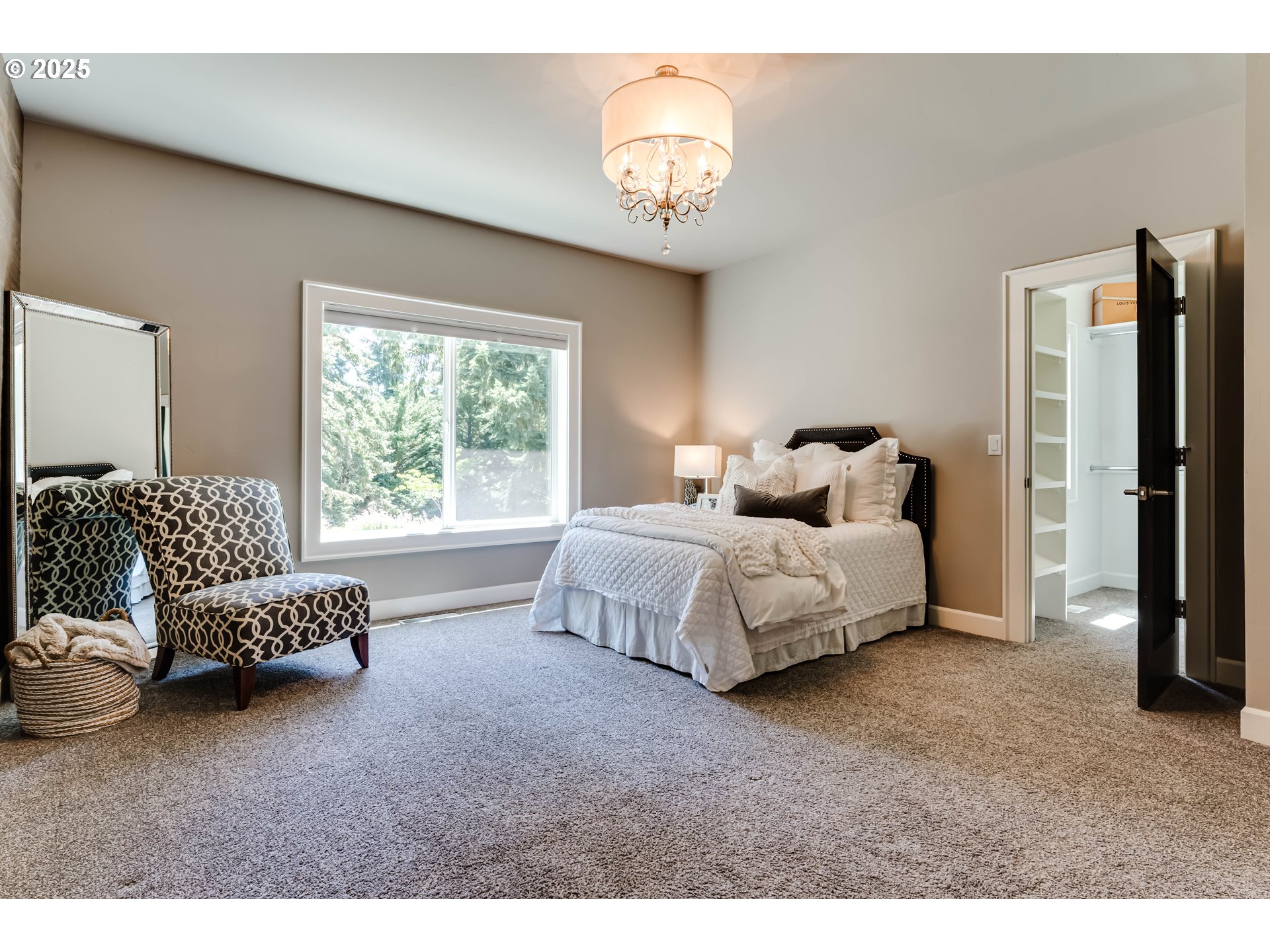 3944 Los Altos Lane Eugene, OR 97405 - Photo 24 of 47 a spacious bedroom with a bed and a chandelier
