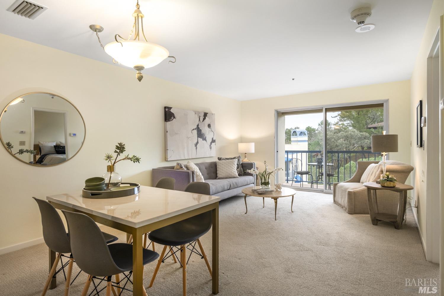 a living room with furniture and a chandelier