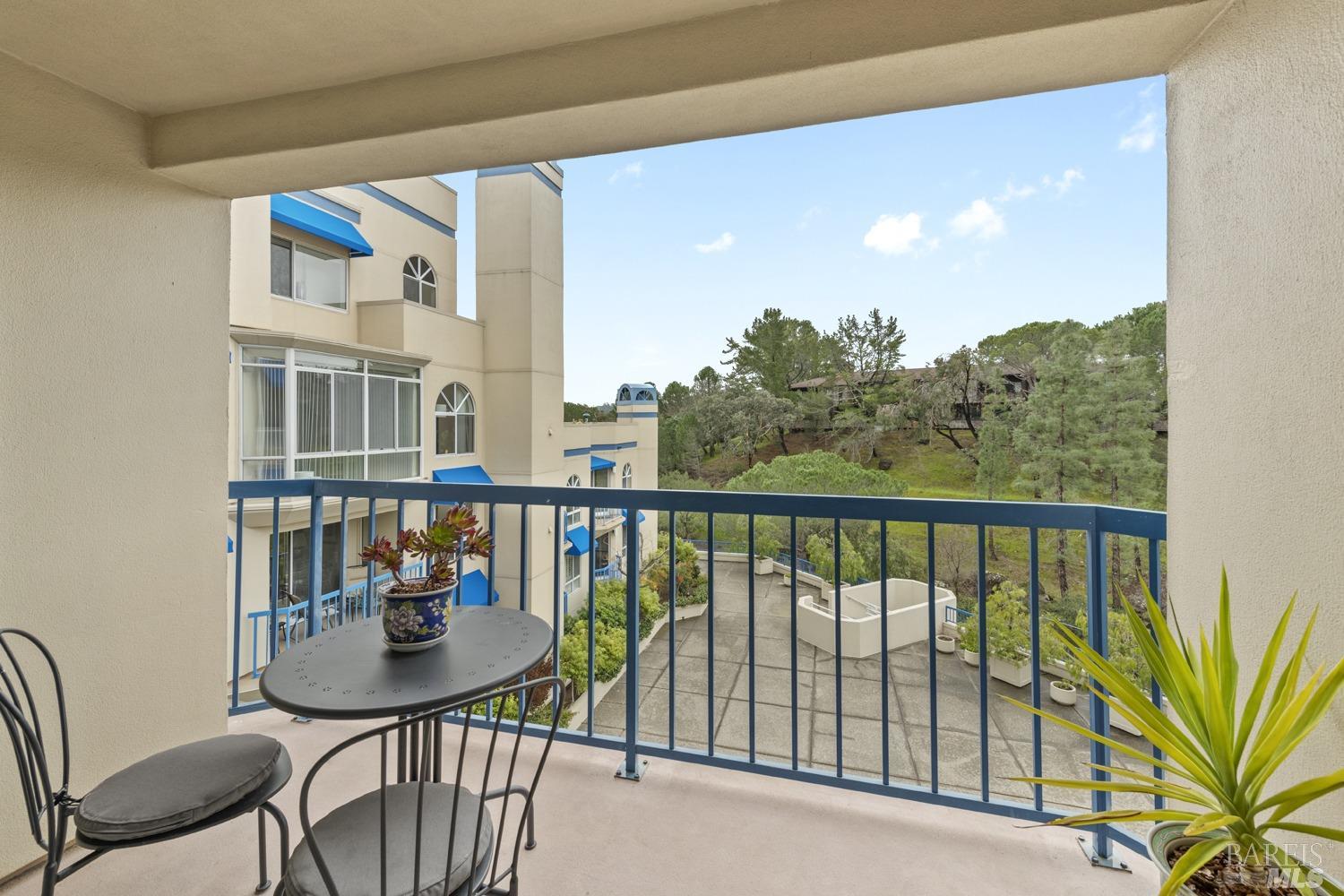 100 Thorndale Drive, Unit 303 San Rafael, CA 94903 - Photo 4 of 32 a view of a balcony with chairs and a potted plant