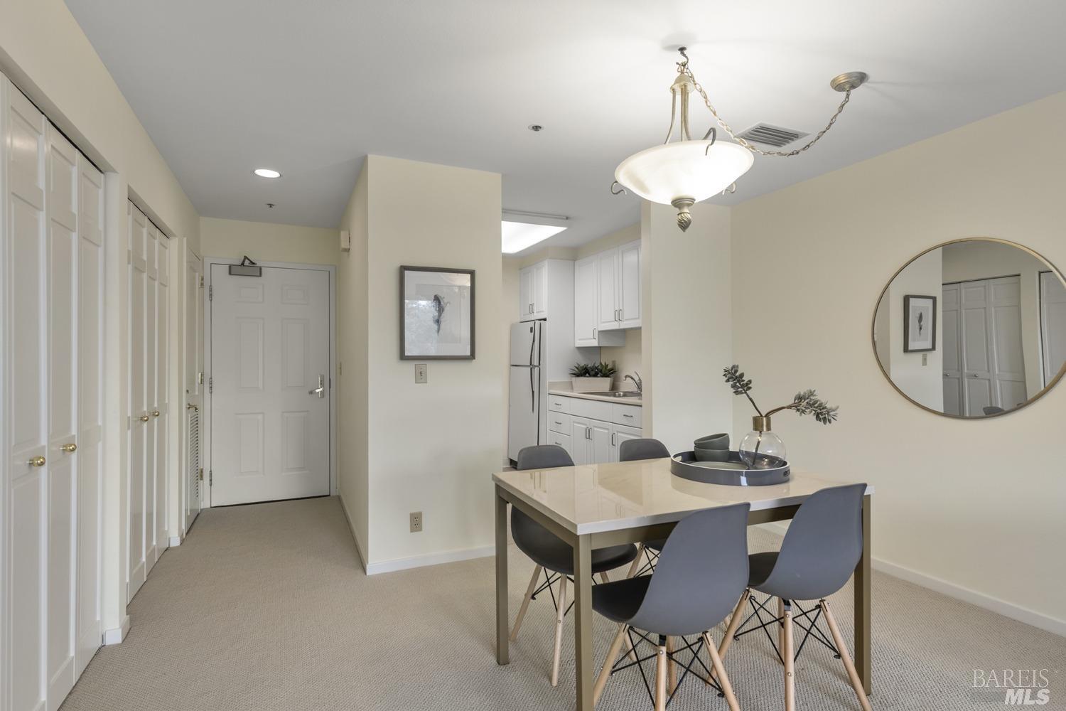 100 Thorndale Drive, Unit 303 San Rafael, CA 94903 - Photo 7 of 32 a view of a dining room with furniture and a chandelier fan