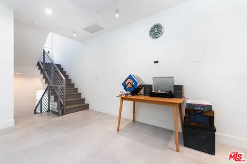 a bathroom with a granite countertop sink a mirror and a potted plant