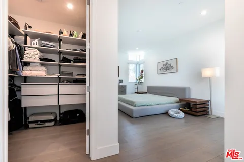 a bedroom with a bed and a night stand