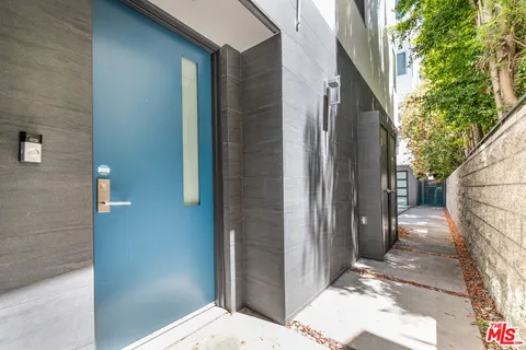 a kitchen with stainless steel appliances kitchen island granite countertop a dining table chairs and sink