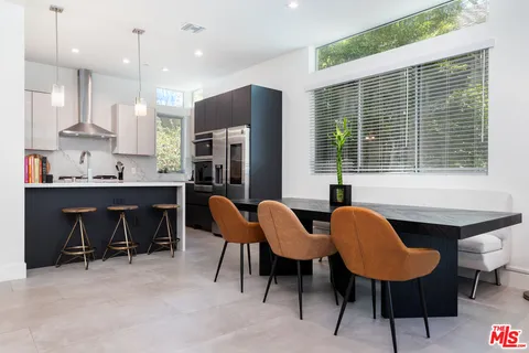 a kitchen with stainless steel appliances a sink stove and refrigerator