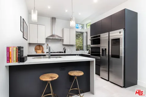 a kitchen with a sink cabinets and window