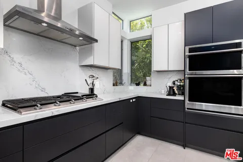 a living room with furniture a window and gym equipment