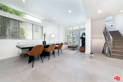 a view of a livingroom with furniture and a window