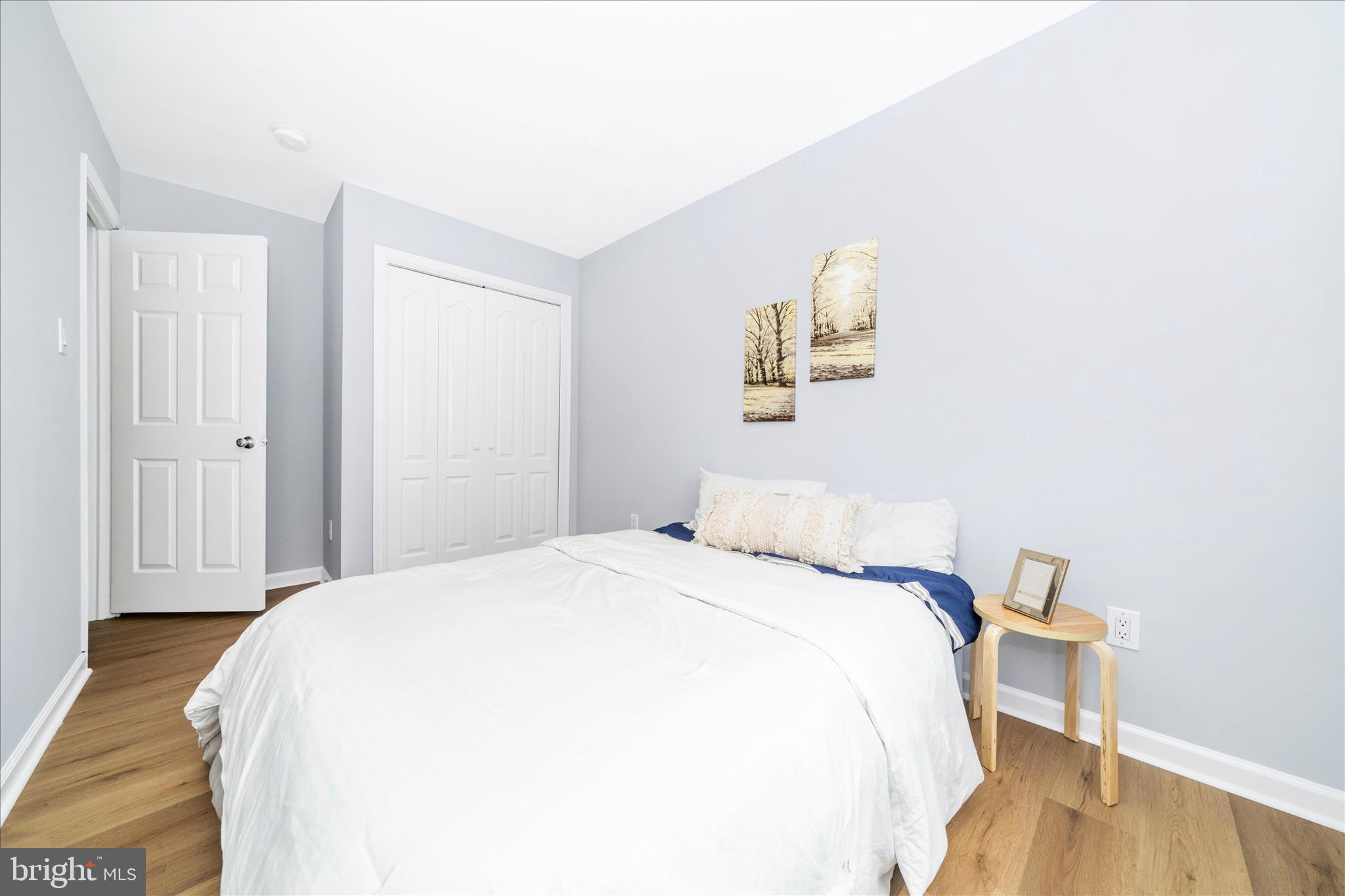 713 Seek Lane Silver Spring, MD 20912 - Photo 21 of 60 a bedroom with a bed and a wooden floor