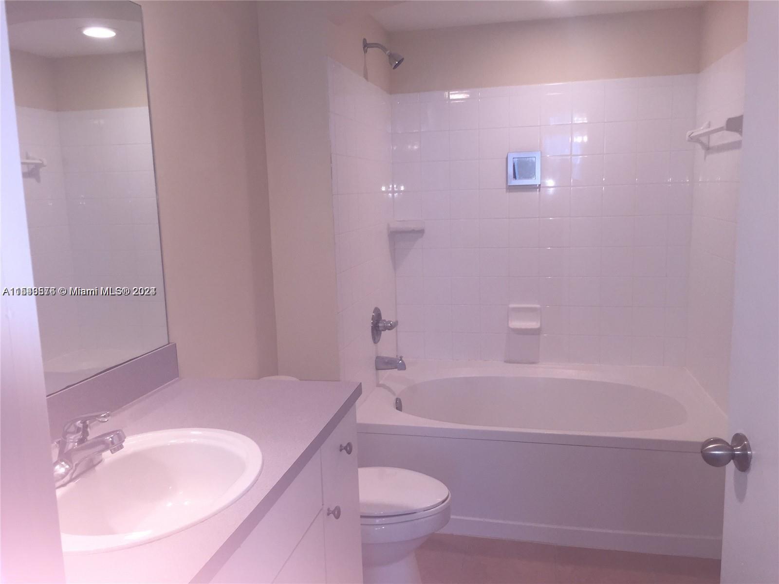 9201 Collins Avenue, Unit 724 Surfside, FL 33154 - Photo 6 of 14 a bath room with a toilet a bath tub and a sink