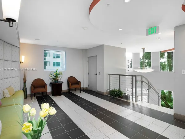 a lobby with furniture and potted plant