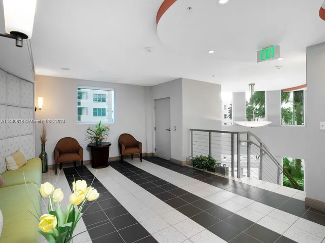 a lobby with furniture and potted plant