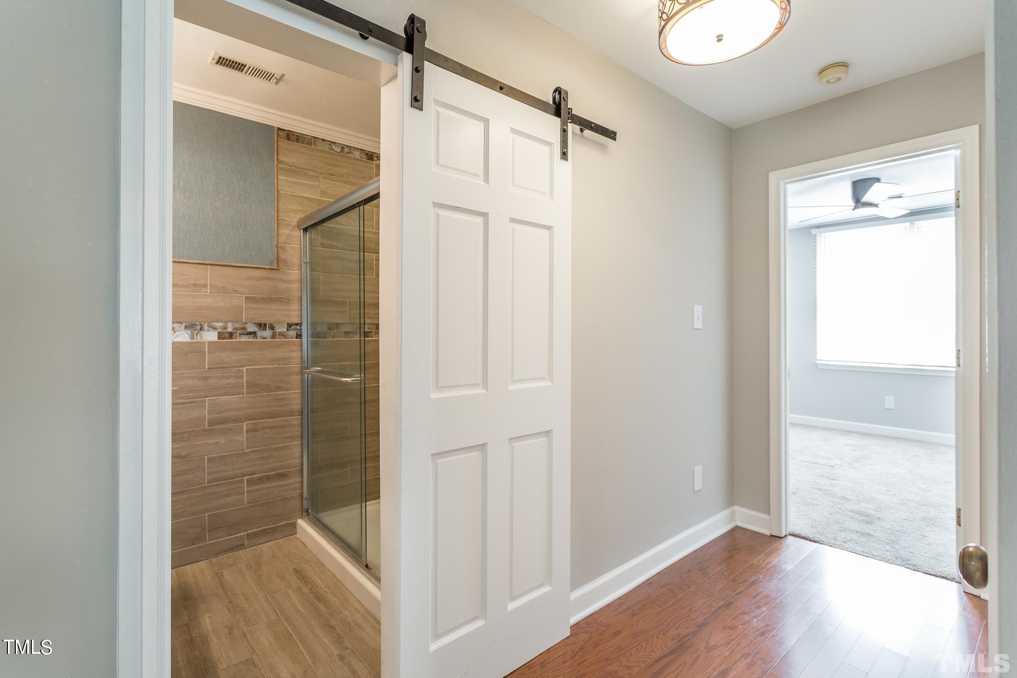 4424 Roller Court Raleigh, NC 27604 - Photo 16 of 19 a bathroom with a shower and a glass door