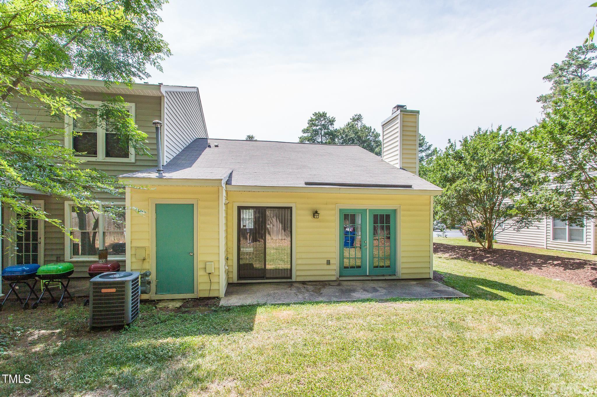 4424 Roller Court Raleigh, NC 27604 - Photo 5 of 19 a view of a house with a backyard and a tree
